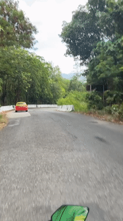 Motorcyclist recorded on wooded road in Chalong, Thailand