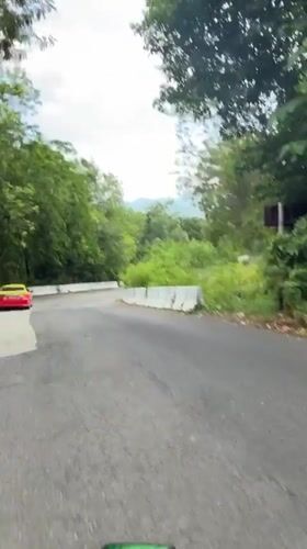 Motorcyclist recorded on wooded road in Chalong, Thailand