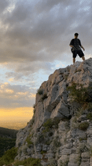 Hiker spotted on rocky cliffs during sunset near Asenovgrad