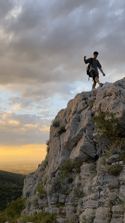 Hiker spotted on rocky cliffs during sunset near Asenovgrad