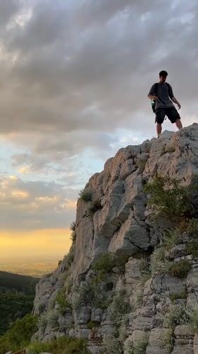 Hiker spotted on rocky cliffs during sunset near Asenovgrad