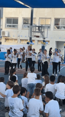 Teenagers perform dance routine in Netanya schoolyard