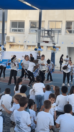 Teenagers perform dance routine in Netanya schoolyard