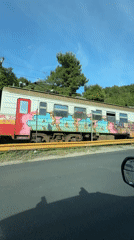 Graffitied train spotted from car in Šušanj, Montenegro