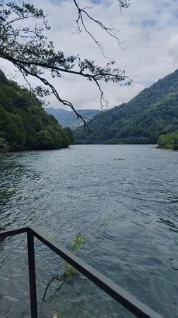 Motorboat on a calm forested river in Mirveti, Georgia