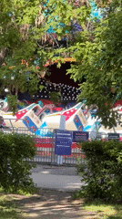 Amusement park rides operate as visitors enjoy casual day out