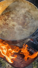Cast-iron stew simmering over open fire in Kulishi