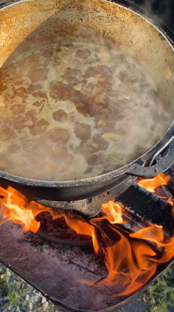 Cast-iron stew simmering over open fire in Kulishi