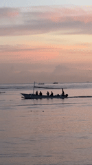 Traditional outrigger boats carry passengers across Buleleng waters at dawn