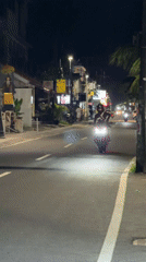 Motorcyclist rides through North Kuta streets at night