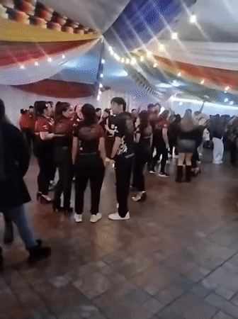 Indoor gathering in Arica under rainbow lights and draped fabric