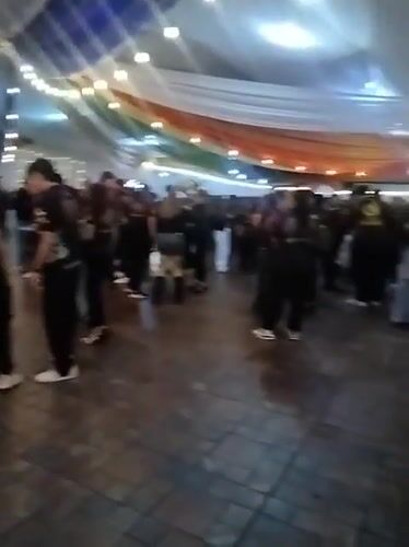 Indoor gathering in Arica under rainbow lights and draped fabric