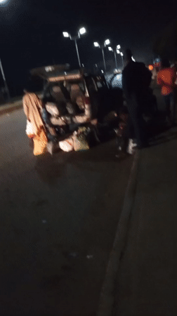 Evening street commerce and heavy transport documented in Nigeria