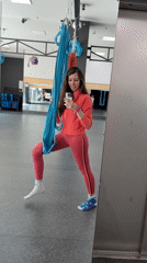 Woman takes selfies in athletic wear at fitness studio