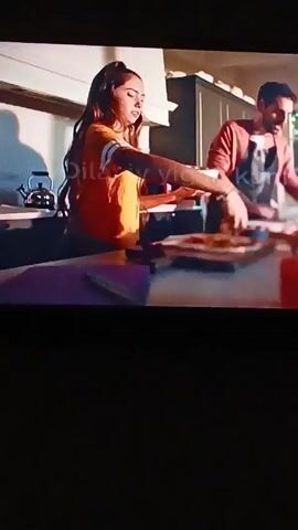 Here is a description of the video:
The video shows a young woman in an orange shirt high-fiving a man. They are standing by a counter. The next scene shows a cooler of various soda bottles, including Coca-Cola and Sprite. The video then cuts to a person holding a Fanta bottle, then to a woman with curly hair.