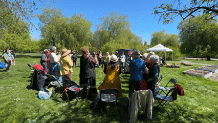 Community drum circle gathers in Vancouver park amid cherry blossoms