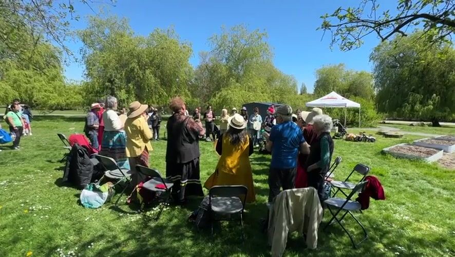 Community drum circle gathers in Vancouver park amid cherry blossoms