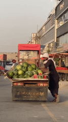 Kandahar street vendors sell fruit during afternoon market hours