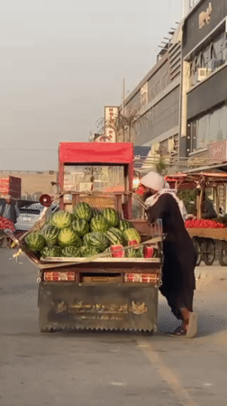 Kandahar street vendors sell fruit during afternoon market hours