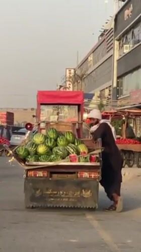Kandahar street vendors sell fruit during afternoon market hours