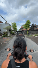 Scooter rider travels through North Kuta streets early morning