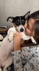 Woman shares tender moment with Jack Russell Terrier in Sofia