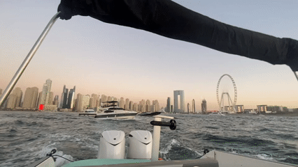 Boat captures Dubai skyline view at dusk