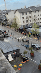 Film crew shoots on wet Brussels cobblestone street