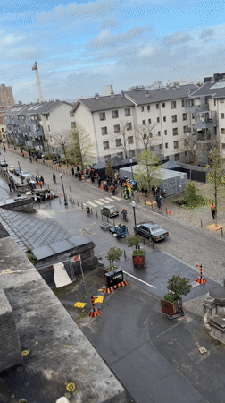 Film crew shoots on wet Brussels cobblestone street