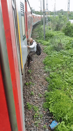 Riding the outside of a moving train through rural India