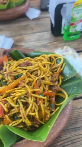 Traditional meal on banana leaf documented in Abuja