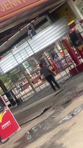 Workers repair damaged roof at Nigerian gas station