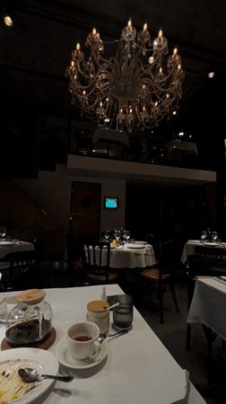 Moscow restaurant interior captured featuring chandelier and dining patrons