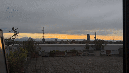 Milan rooftop sunset documented during dramatic evening sky