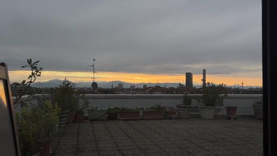 Milan rooftop sunset documented during dramatic evening sky
