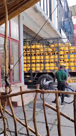 Morning commercial activity: propane delivery, fruit market operations observed