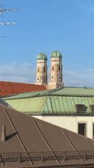 Munich's Frauenkirche towers up close on a clear morning