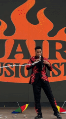 Magic and juggling act on a Nanshan stage, orange flame backdrop