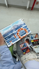 Artist paints watercolor maritime scene aboard ferry near Aegina