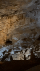Tourists explore and photograph Lipa Cave formations in Montenegro