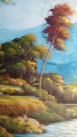This is a painting of a landscape with a body of water in the foreground. There are trees and mountains in the background, and a small house on a hill. The painting is done in a realistic style, with vibrant colors and a lot of detail. The water is clear and reflects the sky and trees. The mountains are tall and majestic, and the house is small and quaint. The painting depicts a peaceful and idyllic scene.