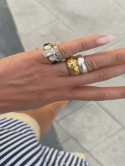 Woman in sunglasses walks Dubai pedestrian walkway wearing jewelry