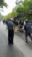 Men transport bamboo sedan chair on road in Zhonghu