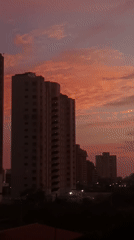 Vivid sunset paints Porlamar skyline in pink and purple