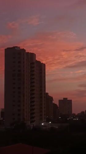Vivid sunset paints Porlamar skyline in pink and purple