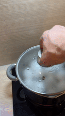 Moscow resident cooks eggs on induction stovetop Monday evening