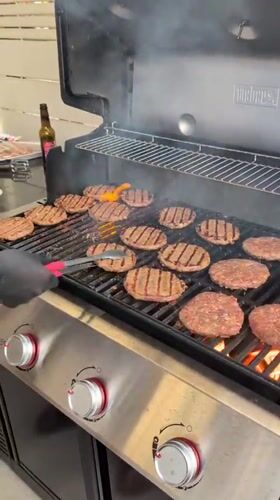Burgers sizzling on a Weber grill in Lod, Israel