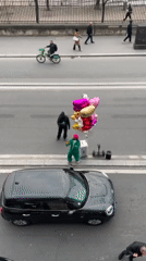 Ordinary street activity observed in Paris on cloudy afternoon