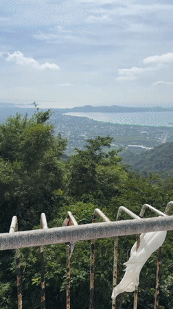 Tourist documents Big Buddha site views in Karon, Thailand