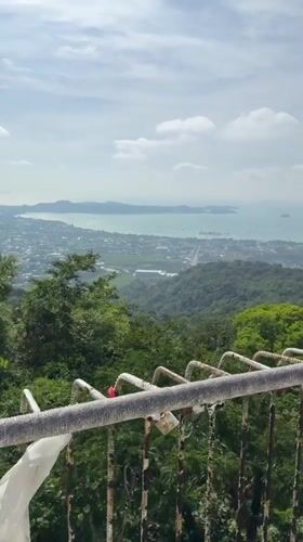 Tourist documents Big Buddha site views in Karon, Thailand